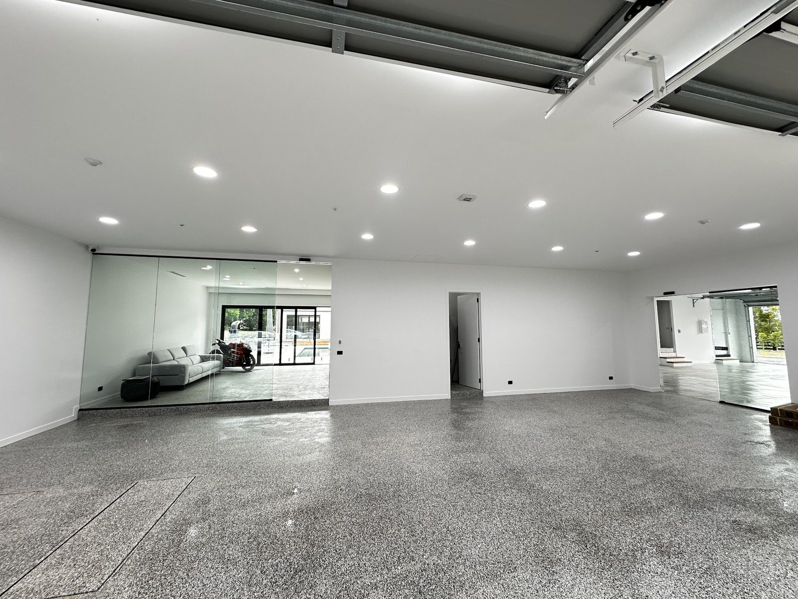 Large garage and workshop with freshly painted white walls and ceiling
